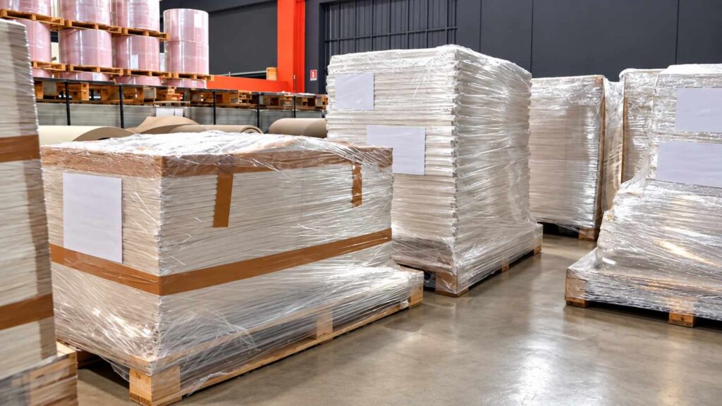 Pallets of packed paper secured with protective film in the RedsPaper warehouse